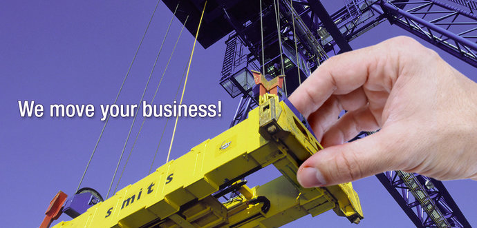 A humen hand is moving a container spreader of a container crane.